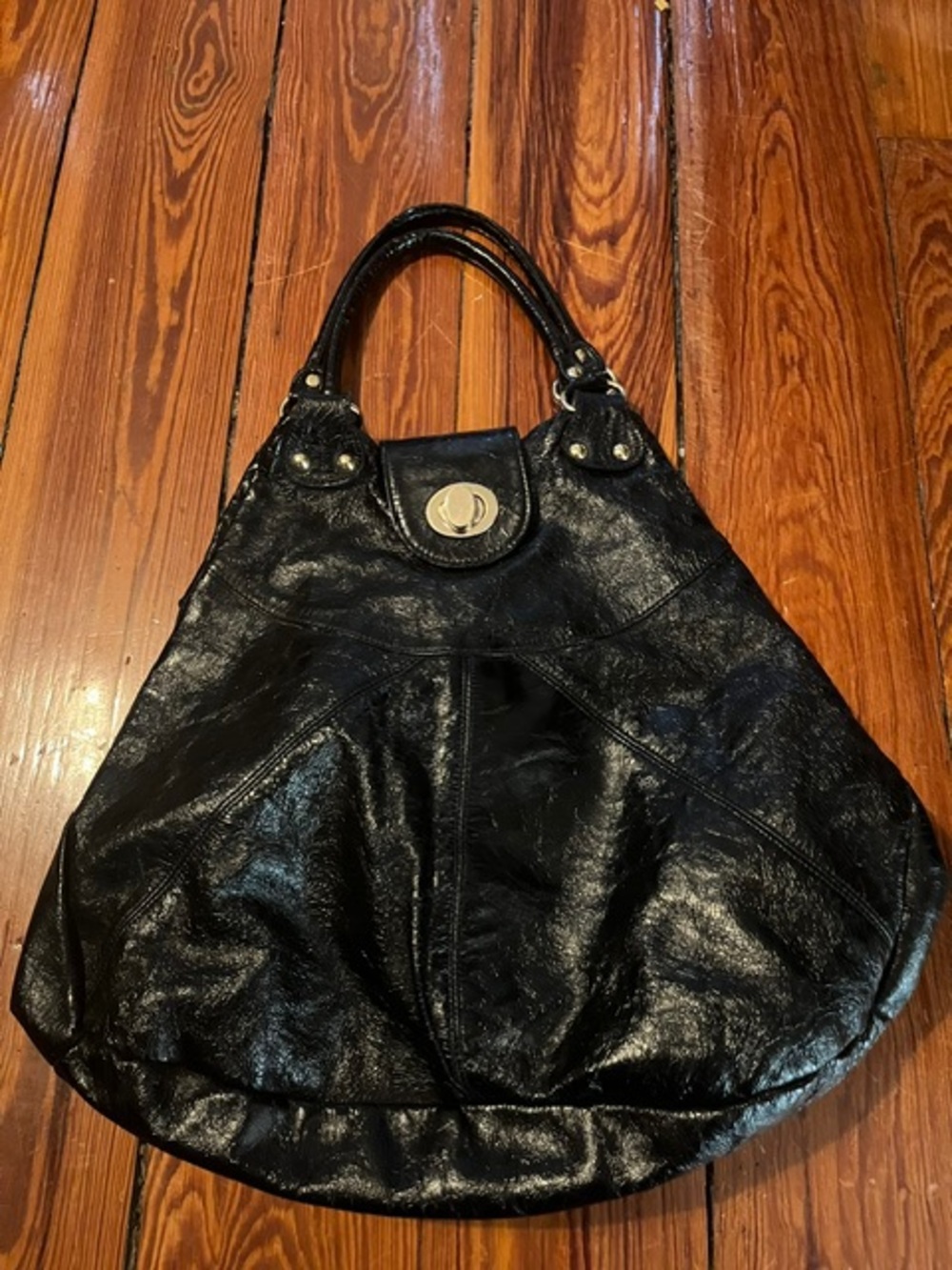 Foley and Corinna Black crinkle patent leather tote bag with gold hardware.